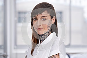 Business, woman and tattoo with portrait in office with confident attitude, serious and pride with mockup space