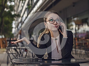 Business woman or teacher talking on the cellphone emotionally