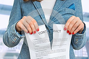 Business woman tearing contract in office