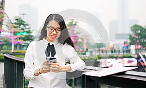 Business woman texting in modern environment