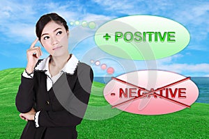 Business woman thinking about positive with green grass field an
