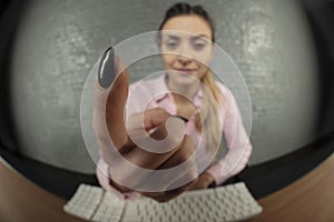 Business woman threatens with finger, blurred background