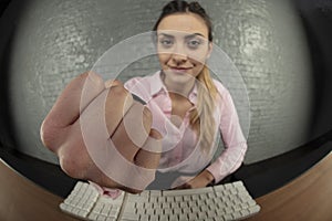 Business woman threatens with fist, blurry background, fist in f
