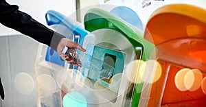 Business woman throwing empty plastic bottle water into recycle garbage trash