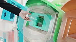 Business woman throwing empty plastic bottle water into recycle garbage trash