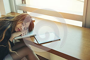 Business woman tired a sleep on the office room while working