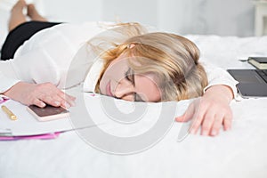 Business woman tired and sleeping in bed