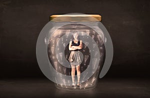 Business woman trapped in jar with exclamation marks concept