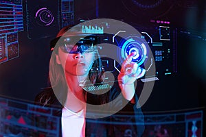 Business woman try vr glasses hololens in the dark room | Portrait of young asian girl experience ar | Future technology concept photo