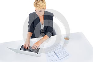 Business woman, typing on computer and studio for accounting, taxes management and budget report. Accountant or worker