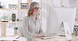 Business woman typing email online on computer, planning on the internet and designing a creative website in an office