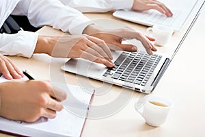 Business woman typing on laptop keyboard