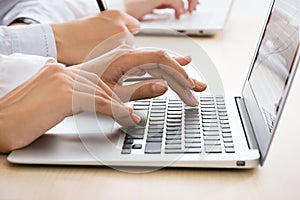 Business woman typing on laptop keyboard