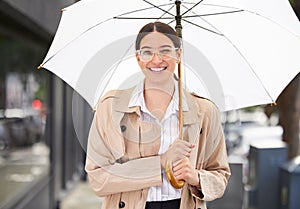 Business woman, umbrella and portrait in city for cover from rain, winter and happy for commute on sidewalk. Person