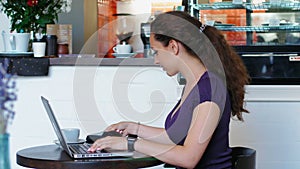 Business Woman use a card with NFC tehnology for payning a bill at cafe. Business meeting in cafe