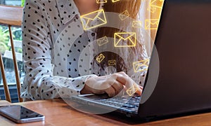 Business woman use tablet with email icons in work space.