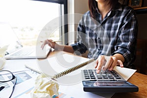 Business woman using calculator in office for calculate accounting and financial as accountant job.