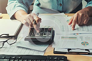 business woman using calculator to calculate of data document