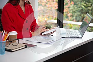 Business woman using a calculator to calculate personal income tax