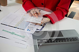 Business woman using a calculator to calculate personal income tax