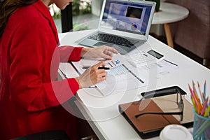 Business woman using a calculator to calculate personal income tax