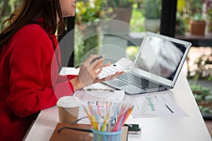 Business woman using a calculator to calculate personal income tax