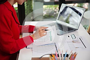 Business woman using a calculator to calculate personal income tax