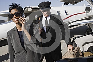 Business Woman Using Cellphone At Airfield photo