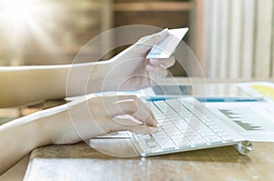 Business woman using computer with a credit card to shopping online.