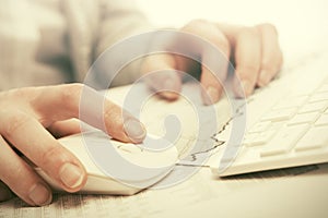 Business woman using computer mouse and keyboard