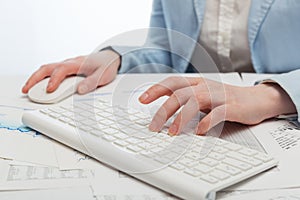 Business woman using computer mouse and keyboard