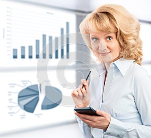 Business woman using her smartphone on the background graphics a