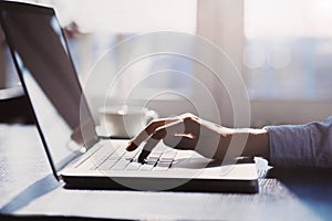 Business woman using laptop computer. Female hand typing on laptop keyboard