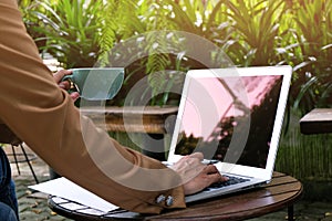 Business woman using laptop computer.works online on laptop which hand on keyboard.