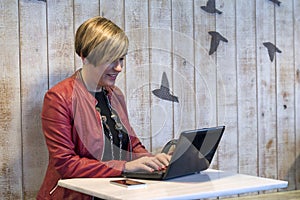 Business woman using laptop while sitting in a cafe