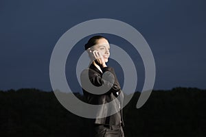 Business woman using mobile phone in field