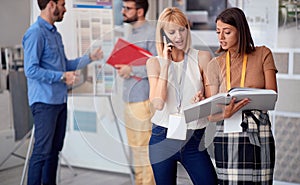 Business woman using a mobile phone and working at store