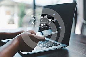 Business woman using smart phone with social network service or SNS, Social media concept. Woman using laptop computer and staying