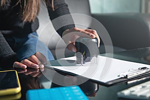 Business woman using stamp on document
