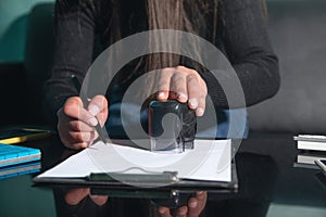 Business woman using stamp on document
