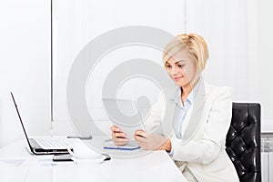 Business woman using tablet bright ofice desk