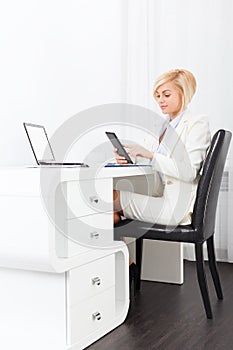 Business woman using tablet bright ofice desk