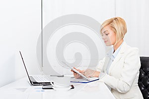 Business woman using tablet bright ofice desk