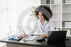 Business woman using tablet and laptop for doing math finance on an office desk, tax, report, accounting, statistics, and