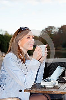 Business woman using tablet on lunch break.