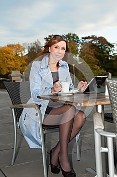 Business woman using tablet on lunch break.