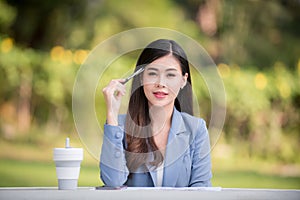 Business woman using tablet on lunch break in city park