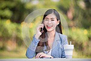 Business woman using tablet on lunch break in city park