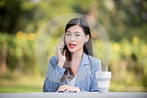 Business woman using tablet on lunch break in city park