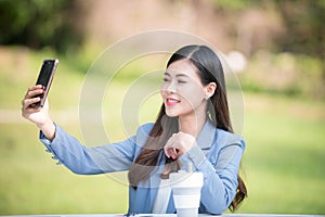Business woman using tablet on lunch break in city park